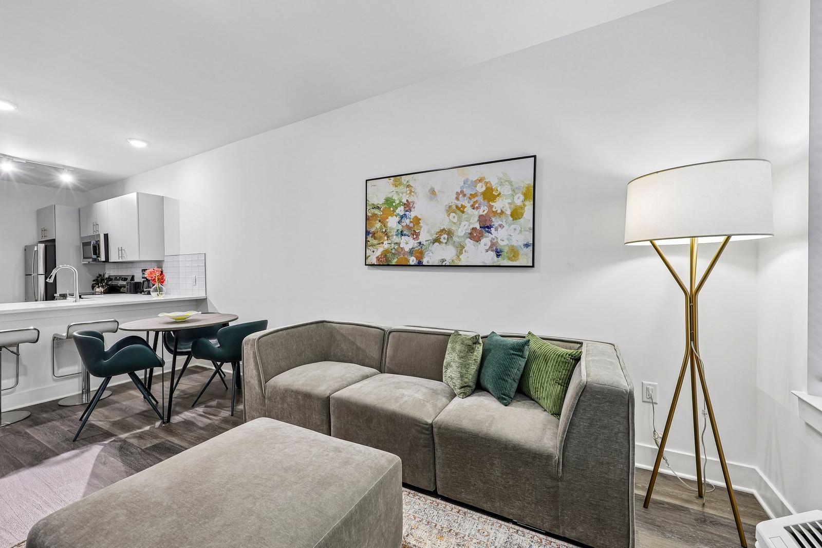 Meridia Pompton Lakes apartment living room with sofa and kitchen in view